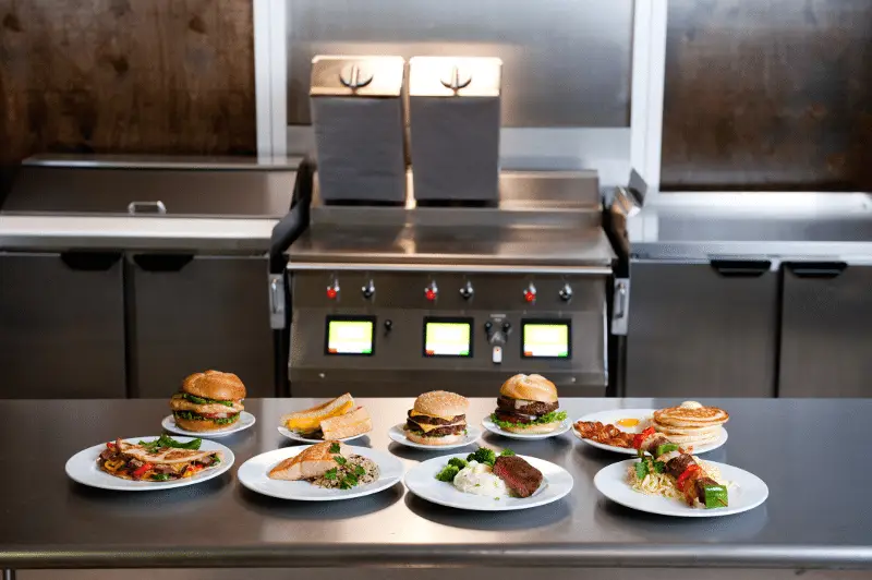 Taylor two-sided grill with plates of burgers in front