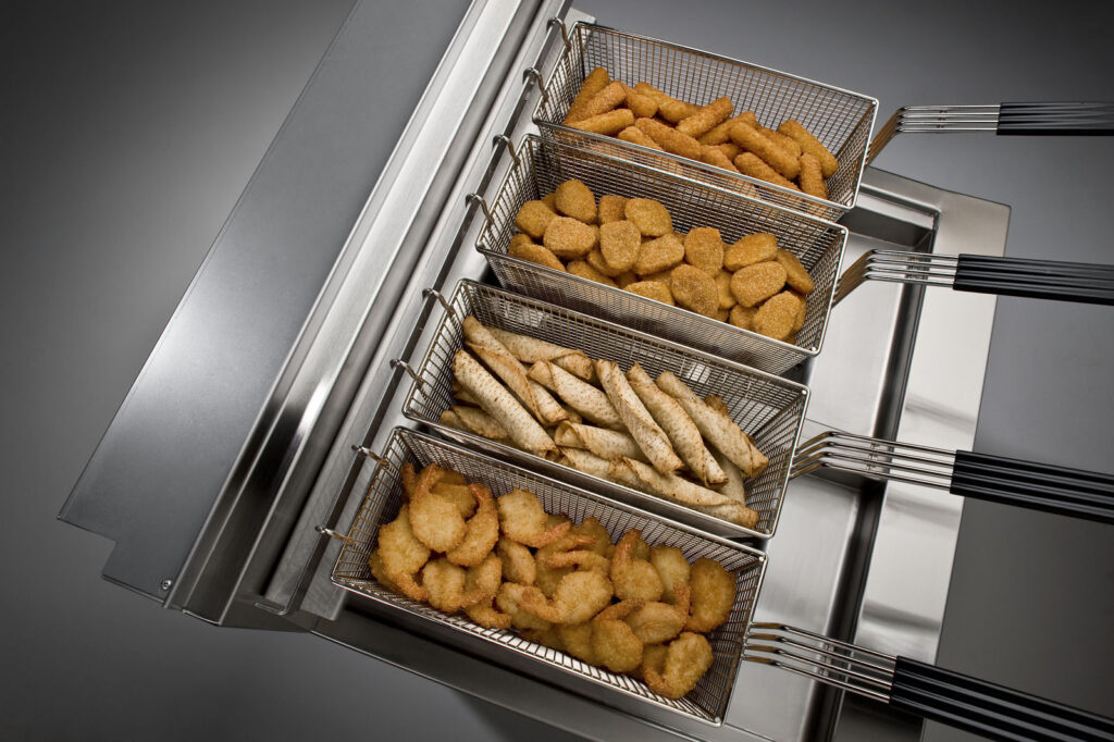 open fryer with wedges and chicken nuggets 