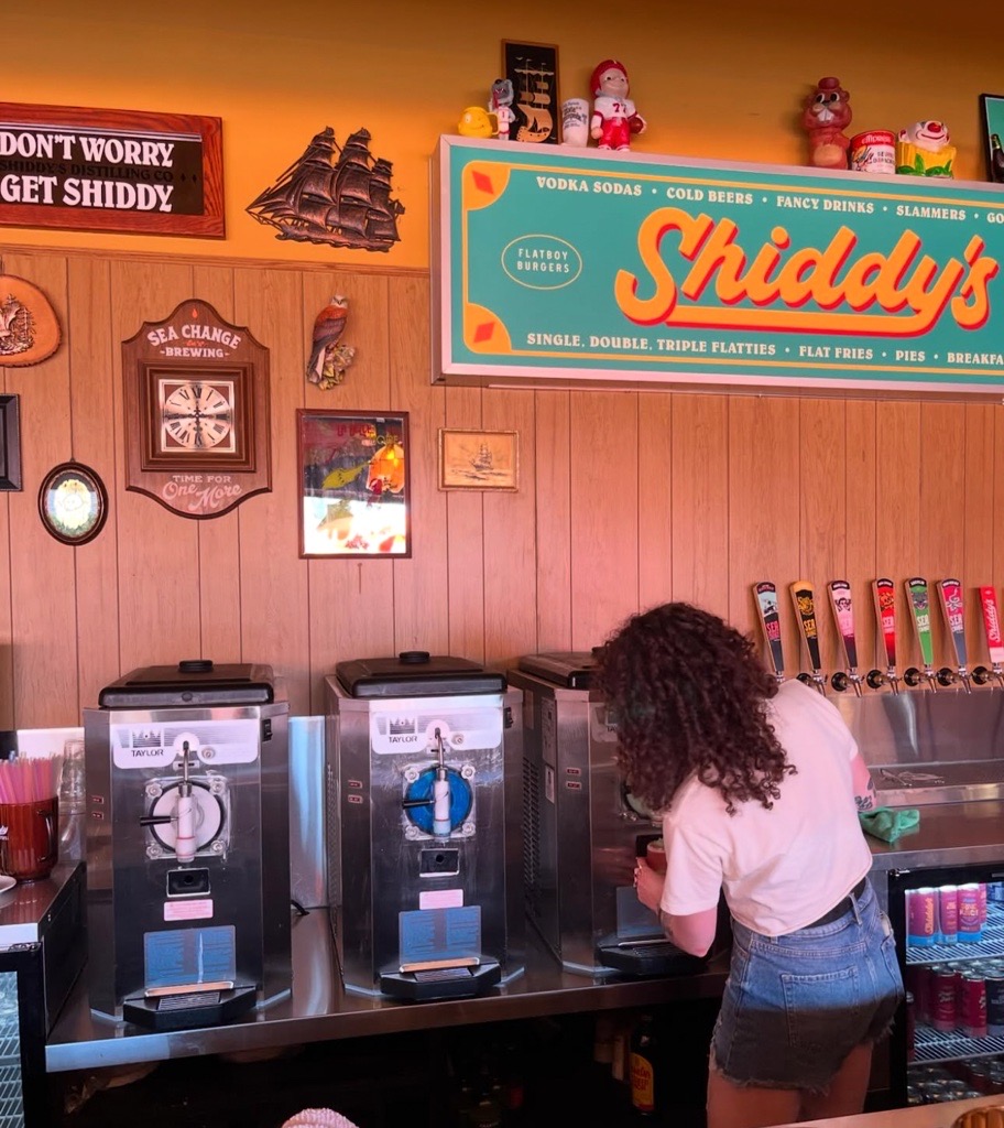 Shiddy's bartending pouring a slush cocktail from a Taylor 430