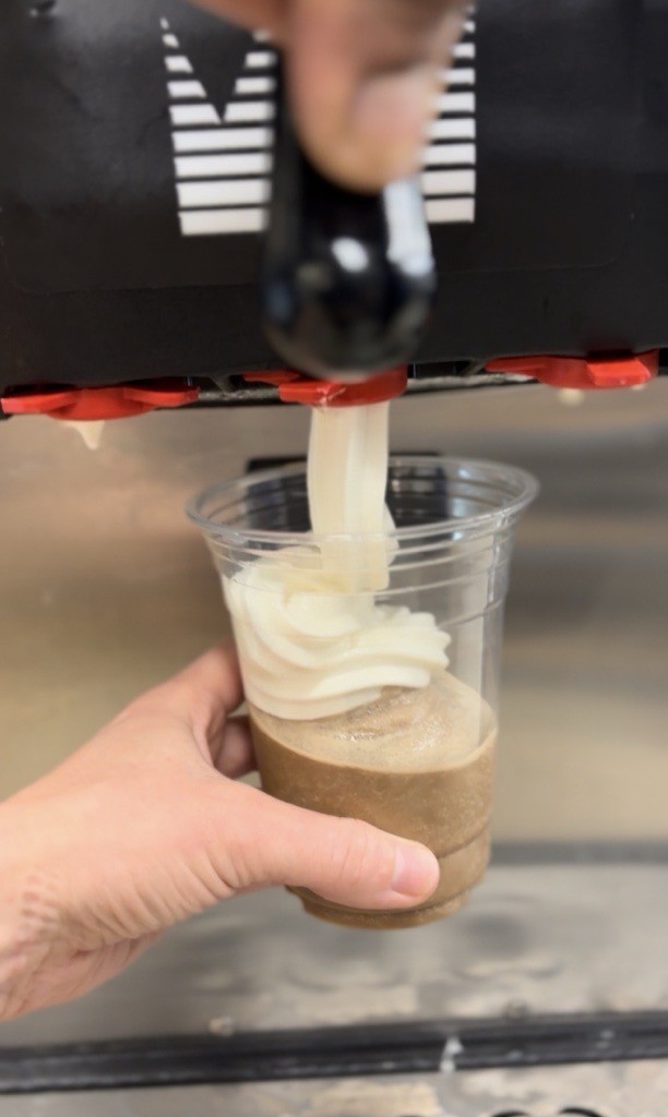 close up of vanilla soft serve from a Taylor machine being poured over a iced java frozen cappuccino drink