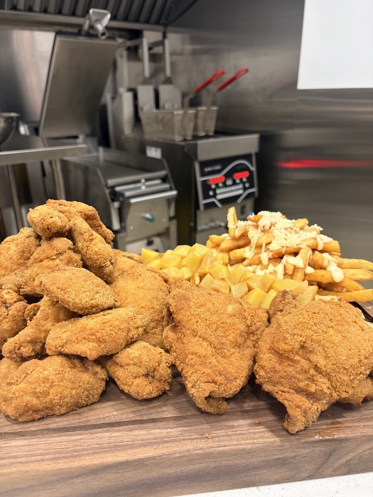 Fried chicken in front of Henny Penny Fryer equipment